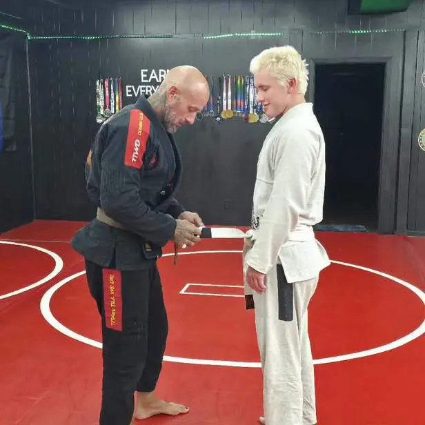 A belt presentation between two grapplers on the Oddfellows mats