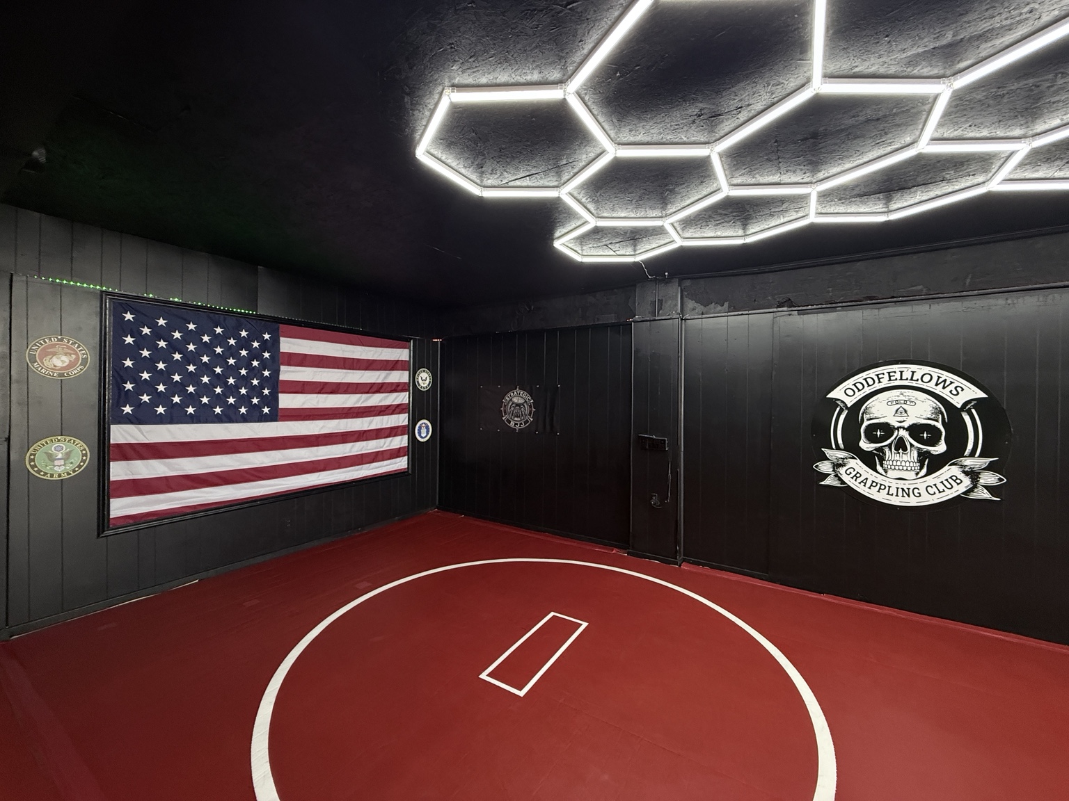 The Oddfellows training room with red mats, black walls and the official club banner